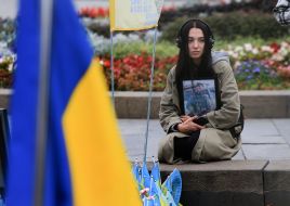 A woman with a portrait of a fallen soldier on Independence Square in Kyiv