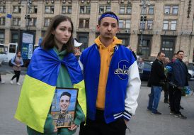 A woman with a portrait of a fallen soldier on Independence Square in Kyiv