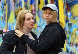 Women honor the memory of fallen Heroes with a moment of silence on Maidan Nezalezhnosti in Kyiv