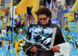 A woman with a portrait of a fallen soldier on Independence Square in Kyiv