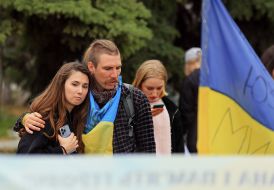 People honor the memory of the fallen Heroes with a moment of silence on Independence Square in Kyiv
