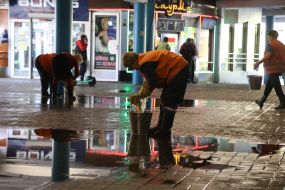 Utility workers clean up the consequences of a water supply network break near the Dorogozhichi metro station in Kyiv
