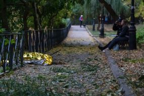 The body of the deceased covered with foil on a path in a park in Kharkiv