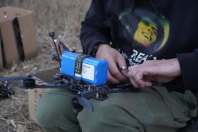 A fighter of the 57th brigade tests new drones before going on a mission at positions in the Kharkiv region