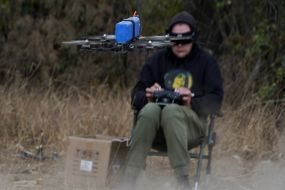 A fighter of the 57th brigade tests new drones before going on a mission at positions in the Kharkiv region