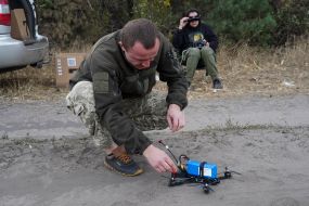A fighter of the 57th brigade tests new drones before going on a mission at positions in the Kharkiv region