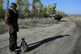 A local resident near a destroyed tank