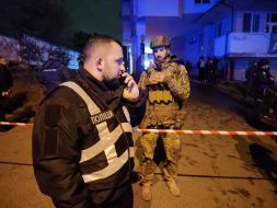 Emergency services are working at the site of a drone strike in a residential building in Kyiv