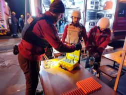 Rescuers work at the site of a drone strike in a residential building in Kyiv