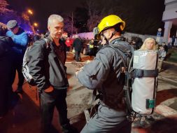 Rescuers work at the site of a drone strike in a residential building in Kyiv