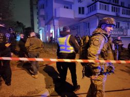 Rescuers work at the site of a drone strike in a residential building in Kyiv