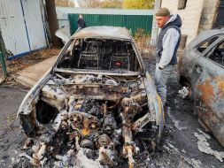 A car destroyed by falling debris of a downed drone in Kyiv