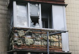 Broken glass on the balcony of a residential building in Kyiv after the debris of a downed drone fell