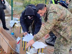 Police officers record war crimes committed by Russian aggressors at the crash site of downed drones in Kyiv