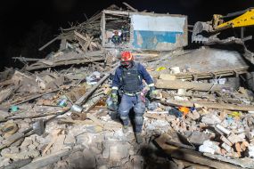 A rescuer in the ruins of a building housing a police station after a missile hit in Kharkiv
