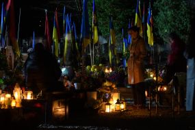 People near the grave of a fallen soldier at the Lychakiv Cemetery in Lviv