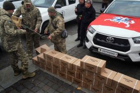 A soldier examines a metal detector