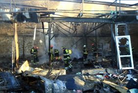 Rescuers extinguish a fire after the wreckage of a drone fell in the Solomianskyi district of Kyiv