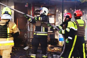 Rescuers extinguish a fire after the wreckage of a drone fell in the Solomianskyi district of Kyiv