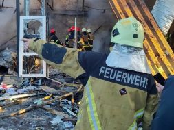 Rescuers extinguish a fire after the wreckage of a drone fell in the Solomianskyi district of Kyiv