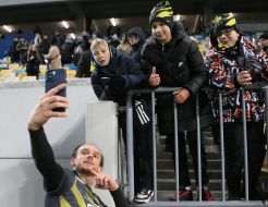 A player from FC Rukh (Lviv) takes a picture with boy fans
