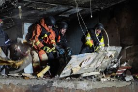 Rescuers clear the rubble of a residential building destroyed by a drone strike in Kharkiv