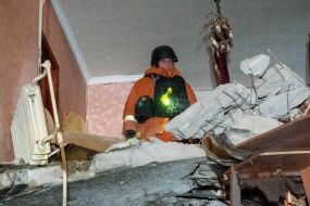 Rescuers clear the rubble of a residential building destroyed by a drone strike in Kharkiv