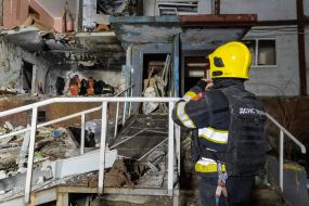 Rescuers clear the rubble of a residential building destroyed by a drone strike in Kharkiv