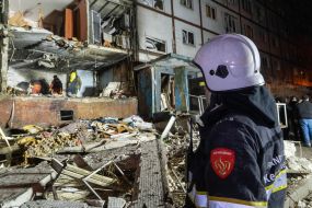 Rescuers clear the rubble of a residential building destroyed by a drone strike in Kharkiv