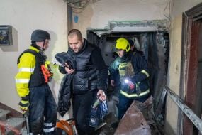 Rescuers evacuate residents from a residential building destroyed by a drone strike in Kharkiv