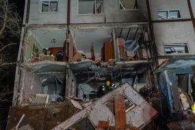 Rescuers clear the rubble of a residential building destroyed by a drone strike in Kharkiv