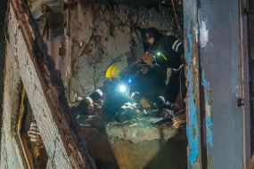 Rescuers clear the rubble of a residential building destroyed by a drone strike in Kharkiv