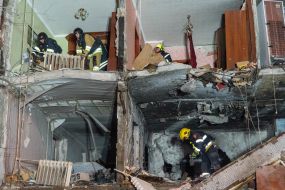 Rescuers clear the rubble of a residential building destroyed by a drone strike in Kharkiv
