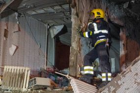 Rescuers clear the rubble of a residential building destroyed by a drone strike in Kharkiv