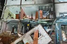 Rescuers clear the rubble of a residential building destroyed by a drone strike in Kharkiv