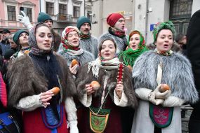 Women with donuts in their hands sing Christmas songs