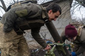 Servicemen of the 57th mortar crew brigade adjust a mortar in the Kharkiv region
