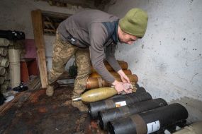 A serviceman of the 57th mortar brigade inspects shells in the Kharkiv region