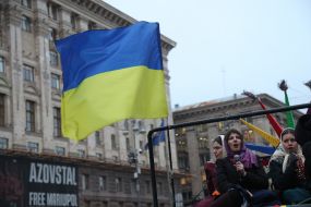 Participants of the Christmas procession in a car with the flag of Ukraine in the center of Kyiv
