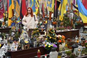 Relatives and friends near the graves of fallen defenders at the Lychakiv Cemetery