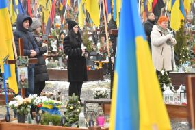Relatives and friends near the graves of fallen defenders at the Lychakiv Cemetery