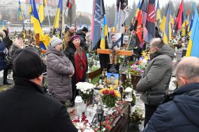 Relatives and friends near the graves of fallen defenders at the Lychakiv Cemetery