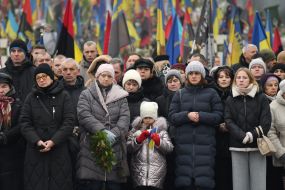 Relatives and friends near the graves of fallen defenders at the Lychakiv Cemetery