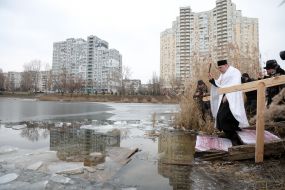 A priest blesses water in Lake Jordan in Kyiv