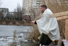 A priest blesses water in Lake Jordan in Kyiv