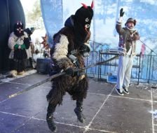 A participant of the Nativity Scene Festival takes part in the devil costume competition