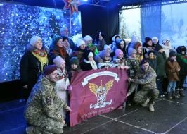Military personnel award participants of the Nativity Scene Festival with a flag
