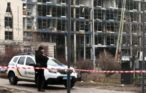 A police car behind a barrier tape at the site of a ballistic missile debris fall in the central district of Kyiv