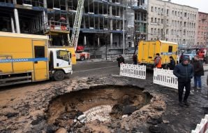 A crater in the middle of the road after debris from a downed missile fell in the central district of Kyiv