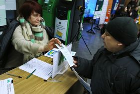 A human resources specialist tells a man about current vacancies